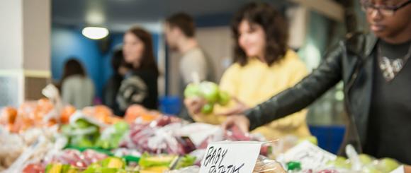 Students buying friuit and vegetables at the Thursday market.