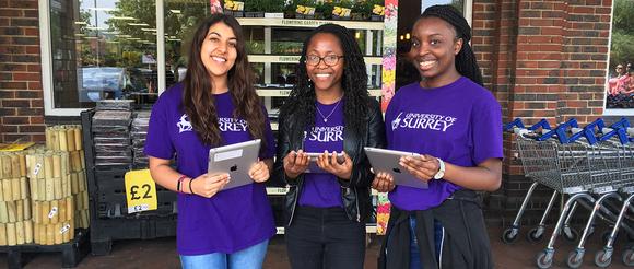 Students taking surveys outside of Tescos in Guildford