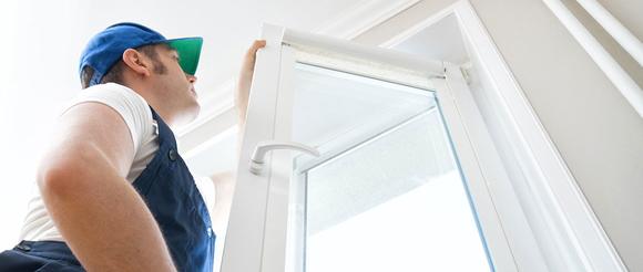 A workman fixing a broken window