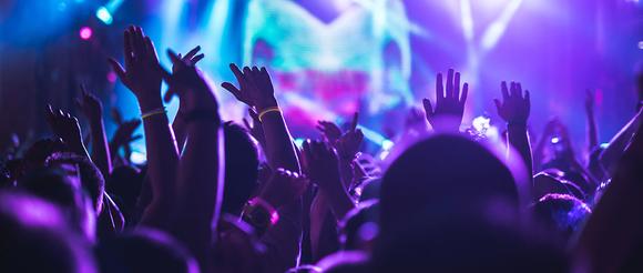 Students dancing with their hands in the air.