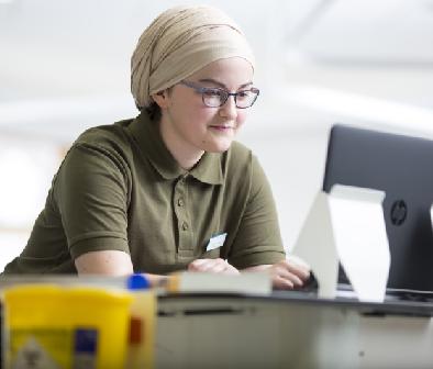 Student using a computer on placement