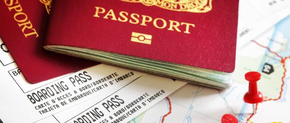 Passports and boarding passes resting on a map.