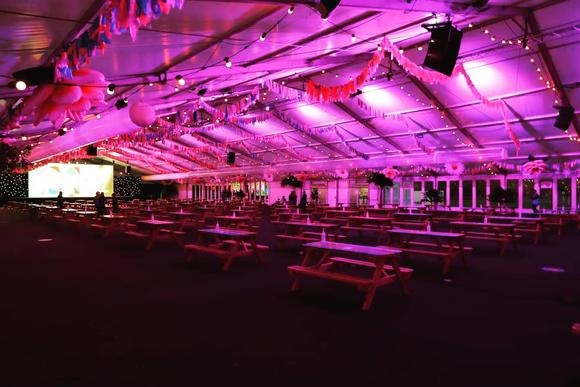 Inside The Marquee showing lots of picnic tables and a big screen