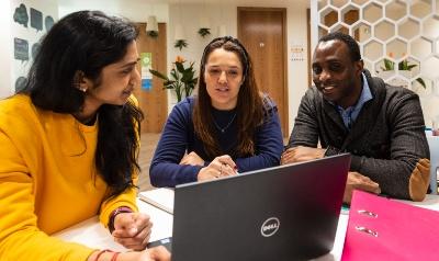 Students around laptop using Equality, Diversity and Inclusion careers resources 