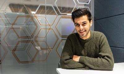 student leaning on desk in study booth