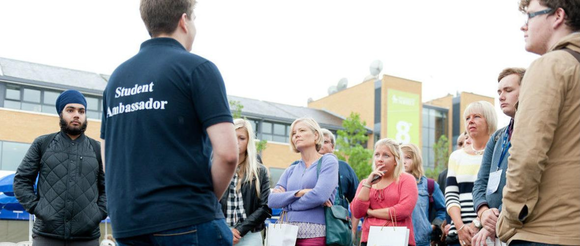 Student Ambassador standing with visitors 