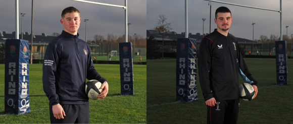 Connor Slevin and Ben Waghorn standing on the rugby pitches at Surrey Sports Park. They are holding rugby balls by their sides and standing in front of the rugby posts