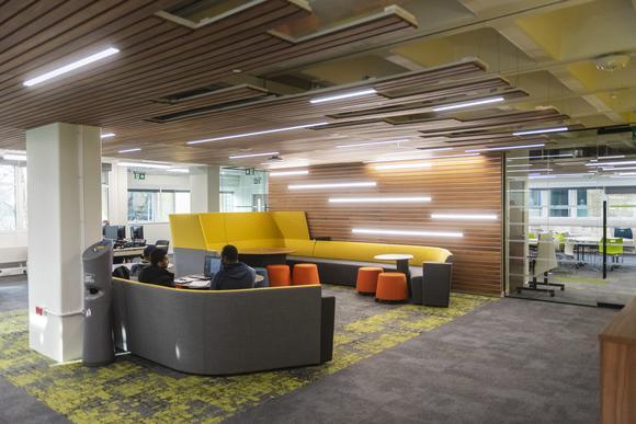 Students sitting on a sofa in the Library