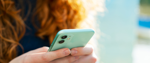 Student holding phone with both hands 